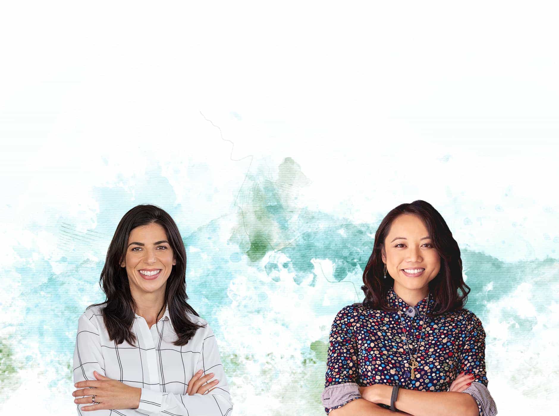 2 women standing in front of a watercolor background.